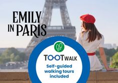 a woman sitting on a ledge in front of the eiffel tower