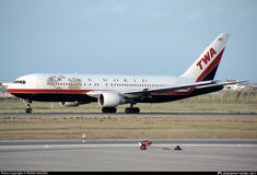 an airplane that is sitting on the tarmac with it's landing gear down