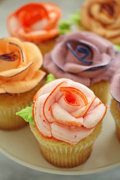 cupcakes decorated with flowers on a plate