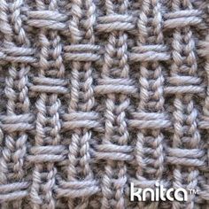 close up view of the knitting stitchs on this knitted blanket, which has been made