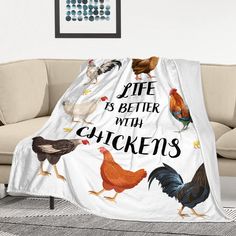 a white blanket with chickens on it that says life is better with chickens