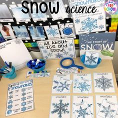 a table topped with snowflakes and cards