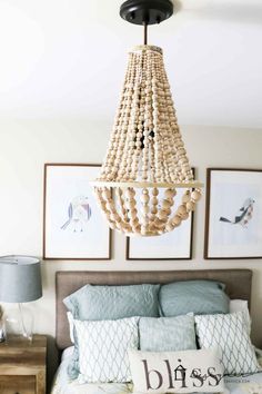 a chandelier hanging from the ceiling above a bed