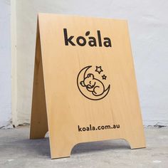 a wooden sign with the name koalaa written in black on it's side