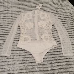 Beautiful White Lacy Noir By Nature Bodysuit Size S & L. Chic Lace Bodysuit For Summer, Spring Sheer White Bodysuit, Sheer White Bodysuit For Spring, Sheer Bodysuit For Spring, White Stretch Bodysuit With Lace Trim, White One-piece Top For Spring, Feminine White Bodysuit For Party, Feminine White Bodysuit For Spring, Spring White Lace Bodysuit