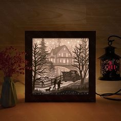 a paper cut scene with a man and dog in front of a house at night