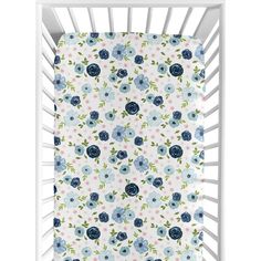 a white crib with blue flowers on it