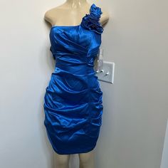 Juno Blue One Shoulder Satin Dress. Box #44 Blue Ruched Dress For Homecoming, Blue Ruched Homecoming Dress, Elegant Blue Mini Dress For Homecoming, Blue Ruched Mini Dress For Formal Occasions, One Shoulder Satin Dress, Dress Box, Satin Dress, Juno, Dress First