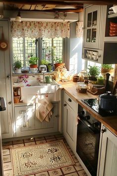 a kitchen with a sink, stove and oven in it's center island next to a window