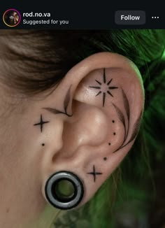 a woman with a cross tattoo on her ear