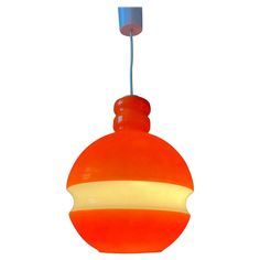 an orange and white light hanging from a ceiling fixture with a blue cord attached to it