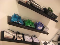 there are many video game controllers on the shelves