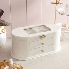 a white jewelry box sitting on top of a table