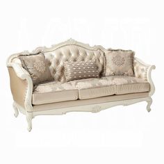 a white couch with many pillows on it's back and armrests, sitting in front of a white background