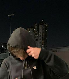 a person wearing a hoodie and pointing at something