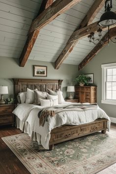 a large bed sitting in the middle of a bedroom next to a dresser and window