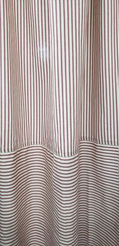 a close up of a curtain with red and white striped material on it's side