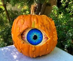 a pumpkin with an eye painted on it