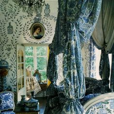 an ornate bedroom with blue and white decor