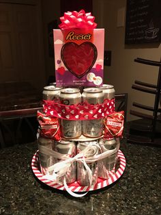 a cake made to look like a stack of cans with hearts on top and candy in the middle