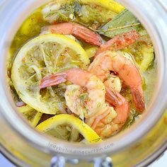 a glass jar filled with lemon and shrimp