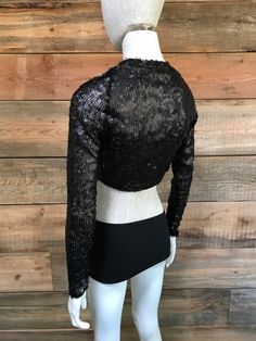 "This shrug is perfect for upcoming holiday parties, as well as any night out that you deserve a little sparkle. It's a great piece to thrown on over a cocktail dress or even a tee and jeans for style, and for a bit more coverage. This most recent cut shapes elegantly around the ribcage and hits a length in the middle of the back. Sizes: S (4-6 women's US size), M (6-8 women's US size) -Fabric content: sequin mesh. Spot clean & Dry clean only. -Feel free to message with any questions or cust Fitted Sequined Tops For Holiday Party, Fitted Sequin Party Tops, Disco Style Tops For Night Out In Fall, Winter Party Fitted Shrug, Fall Disco Night Out Tops, Festive Sequined Crop Top For Party Season, Festive Sequin Crop Top For Party Season, Fall Shrug For Night Out, Glamorous Winter Tops For Night Out