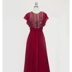 The Attractive Dress Decorated With Sparkling Sequins Has A Light Skirt, A Functional Zipper At The Back That Provides A Secure Fixation Of The Dress. The Back Is Decorated With A Fisheye Keyhole The Sleeveless Dress Has A Tulle Train On The Shoulders. Length: Long Colour: Burgundy Neckline: Jewel Silhouette: A-Line Sleeve: Sleeveless Back: Zipper, Fisheye Keyhole Embellishments: Sequins Occasion: Romantic Date/Evening/Dinner, Wedding/Bridesmaid, Graduation, Fashion Show, Visiting Theater/Museum Sleeveless Red Chiffon Evening Dress, Red Sleeveless Chiffon Evening Dress, Festive Chiffon Dresses With Sequins, Festive Sequin Chiffon Dresses, Sleeveless Embroidered Maxi Dress For Evening, Festive Embroidered Dress For Prom, Red Sleeveless Festive Evening Dress, Red Sleeveless Embroidered Dress, Sleeveless Embellished Bridesmaid Maxi Dress