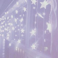 the stars are hanging from the curtain in the room