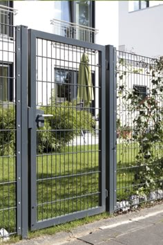 an iron fence with bars on the top and bottom is shown in front of a house