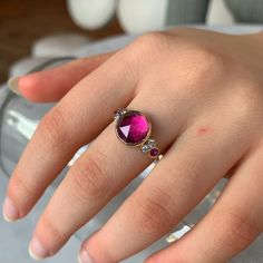 Bright pink sapphires and brilliant white diamonds flank the shoulders of this rosecut pink tourmaline. Set in 14k yellow gold with emily's signature seagrass band we know it will become a staple in your collection. Approximate stone size: 10mm x 10mm Approx ct weight: 3.3cts Mohs Hardness: 7-7.5 This one of a kind piece is handmade with love in Emily's Hudson Valley studio and ready to size and ship. If you have questions about sizing, shipping or custom orders please reach out to us! Pink Ruby Ring With Rose Cut Diamonds, Pink Ruby Ring With Rose Cut Diamonds For Promise, Pink Ruby Promise Ring With Rose Cut Diamonds, Pink Ruby Ring With Gemstone Accents, Watermelon Tourmaline Ring, Orange Pink Color, Green Tourmaline Ring, Pink Tourmaline Ring, Ring With Diamond