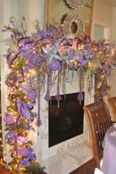 a fireplace decorated for christmas with purple ribbons