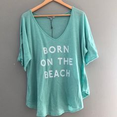 Wildfox New Born On The Beach Tee Never Worn. Turquoise Color Blue Tops For Loungewear During Beach Season, Light Blue Relaxed Fit Beach Top, Light Blue Crew Neck Summer Top, Turquoise Cotton Beach Tops, Light Blue Tops For Vacation, Light Blue Relaxed Fit Tops For Beach Season, Light Blue Relaxed Fit Summer Top, Turquoise Crew Neck T-shirt For Summer, Light Blue Summer Vacation T-shirt