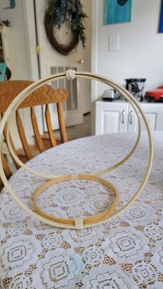 a close up of a table with chairs and a doily on the dining room table