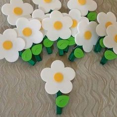 a bunch of white flowers sitting on top of a brown table next to each other