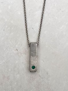 "Unique Silver Bar Textured Pendant Necklace For Men, Unique Emerald Silver Jewelry, Handmade by OmriGoren. This is a 925 sterling silver necklace and a hand-made textured silver bar pendant. A beautiful piece of raw emerald is held in a frame set as a centerpiece. This truly Unique Bar Necklace For Men is the perfect piece of jewelry for meaningful events Or everyday outfits, an art piece that cannot be ignored! My new unique men's jewelry collection combines metals and gemstones, creating a un Luxury Men's Jewelry With Rectangular Pendant, Men Necklace Silver With Stone, Unique Mens Necklace, Mens Silver Pendants, Emerald Necklace Pendant, Raw Emerald, Silver Bar Necklace, Bar Jewelry, Mens Silver Necklace