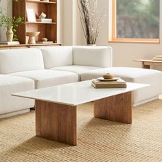 a living room with a white couch and coffee table