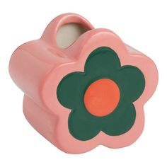 a pink and green flower shaped container with an orange center in the middle, on a white background