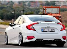 the rear end of a white honda civic