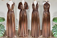 three dresses on mannequins, one in bronze and the other in brown