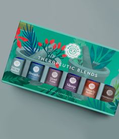 theraputic blends gift set in a box on a grey background with tropical leaves