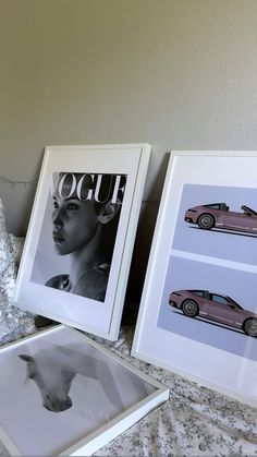 three framed photographs sitting on top of a bed