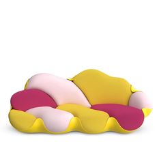 a yellow and pink couch sitting on top of a white floor