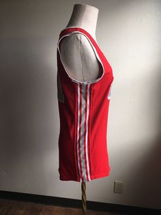 "Vintage spots sleeveless jersey label- Athletic Supply label size 38 (please go by measurements) red with grey and white side stripes and neck stripes 21 patches on front and back good condition w/wear normal to age no fabric info tag feels partly elastic/stretchy measures, lying flat, shoulder- 13 1/4\" chest- 18\" hem- 18 1/4\" length- 29\"" Team Spirit Red Sleeveless Tops, Retro Red Sleeveless Tank Top, Collegiate Red Sleeveless Top, Red Collegiate Sleeveless Top, Sporty Sleeveless Tank Top For Game Day, Red Sleeveless College Tops, Red Sleeveless Tops For College, Collegiate Sleeveless Tops For Basketball, Sleeveless Varsity Top For Game Day