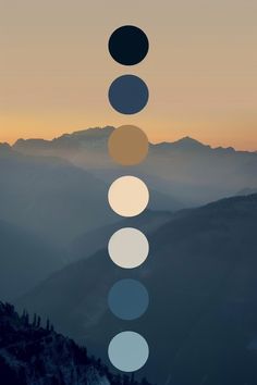 the seven chakras are arranged on top of a mountain at sunset with mountains in the background