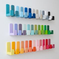 several colorful shelves are arranged on the wall