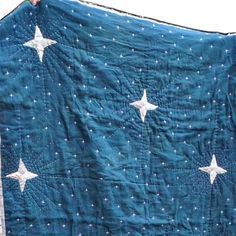 a blue quilt with white stars on it