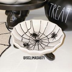 halloween decorations with black and white spiderweaves in the center, on top of a table