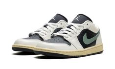 The Women’s Air Jordan 1 Low "Jade Smoke" is a women’s-exclusive colorway of the retro basketball shoe that is reminiscent of Travis Scott’s collaborative version of the model.  Inspired by Travis Scott’s Air Jordan 1 Low “Olive,” the “Jade Smoke” has a similar color block as the hip-hop star’s take on the model.  Specifically, the upper is complete with an Anthracite-colored leather base and Sail leather overlays.  A Jade Smoke leather Swoosh can be found on either side of the shoe, while a whi Air Jordans Stadium Goods, Jordan Shoes Stadium Goods, Womens Air Jordan 1, Womens Air Jordan, Retro Basketball Shoes, Retro Basketball, Stadium Goods, Air Jordan 1 Low, Jordan 1 Low