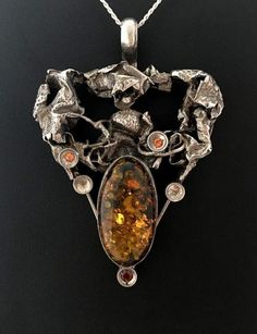 UNIQUE AMBER PENDANTHand-made Sterling Silver.      Stones used: Amber, Garnet, Citrine.Height - 80mm, Width - 56mm.Unique Handcrafted One-of a-kind Design Pendant.Each Piece of Jewelry in my Collection is One of a kind.When you start wearing a piece of my jewelry you will fall in love with it more and more each day and feel that good energy that I pass into it while creating this piece of Art. I use only natural unique stones and unique technics creating my jewelry.You will be the only person i Luxury Sterling Silver Gemstones For Jewelry Making, Handmade Pendant Gemstones For Formal Occasions, Luxury Sterling Silver Gemstones With Stone Setting, Unique Polished Silver Gemstones, Handmade Sterling Silver Gemstones For Collectors, Artisan Silver Gemstones With Stone Setting, Antique Sterling Silver Multi-stone Jewelry, Antique Multi-stone Sterling Silver Jewelry, Luxury Silver Pendant Gemstone