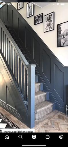 an image of a staircase with pictures on the wall and carpeted stairs in front of it